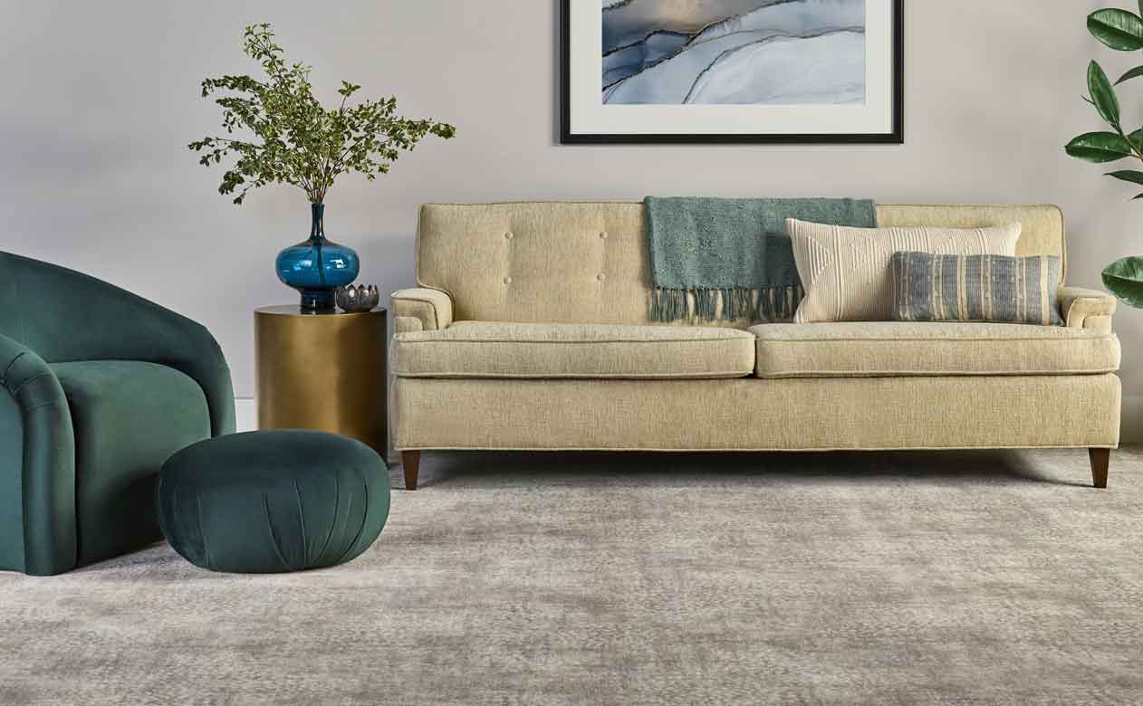 Gray carpet in living room with cream and green furniture